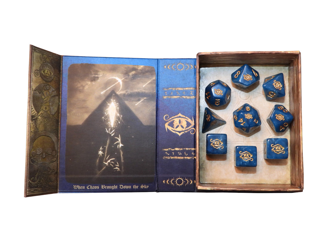 blue with gold Eye of chaos polyhedral dice set in spellbook grimoire